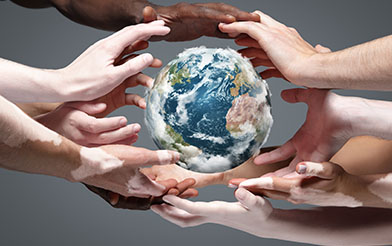 Hands around a globe.